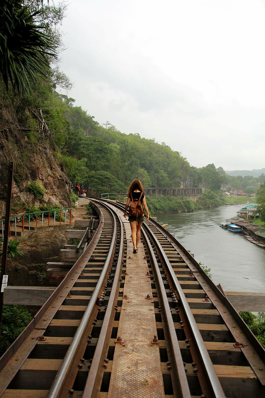woman waling, brown, metal rail road, daytime, adventure, vias, railway, platform, train, rails