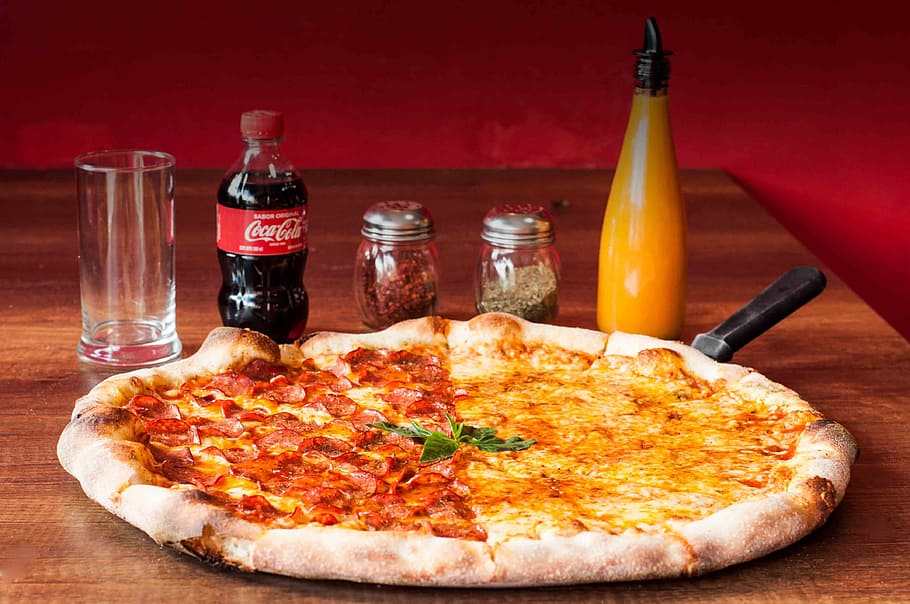 pepperoni pizza, soda bottle, pizza, food, snack, food and drink, table, bottle, ready-to-eat, cheese