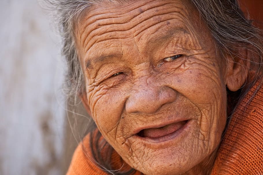 macro shot, person, wearing, orange, knitted, top, old lady, smile, beautiful, woman