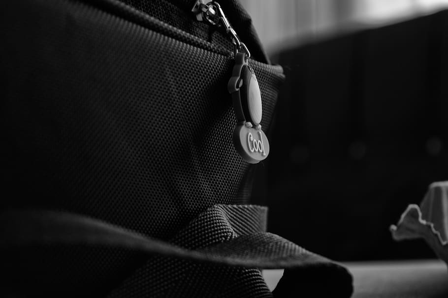 bag, zipper, strap, blur, black and white, focus on foreground, close-up, hand, one person, midsection