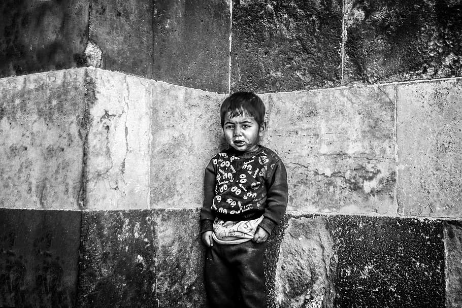 grayscale photo, boy, standing, corner, wall, child, sadness, baby, face, street children
