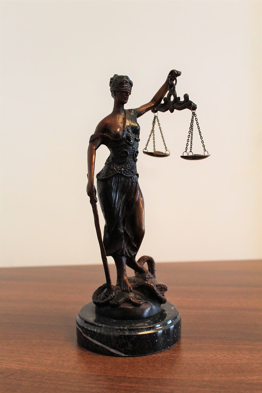 person, holding, balance scale figurine, brown, wooden, surface, justitia, justice, blindness, horizontal