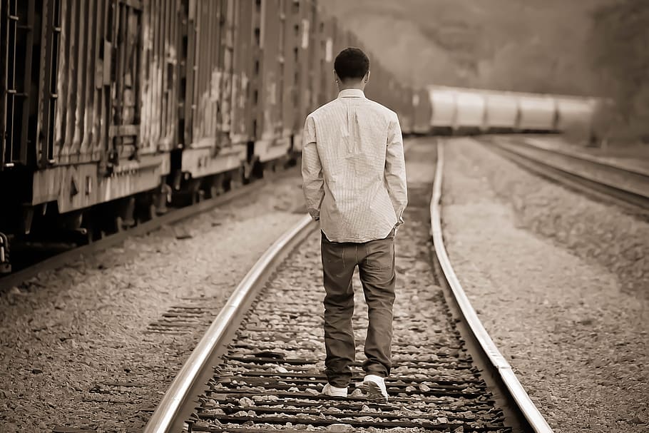 grayscale photo, man, walking, train railway, boy, adventure, teen, people, outdoor, guy