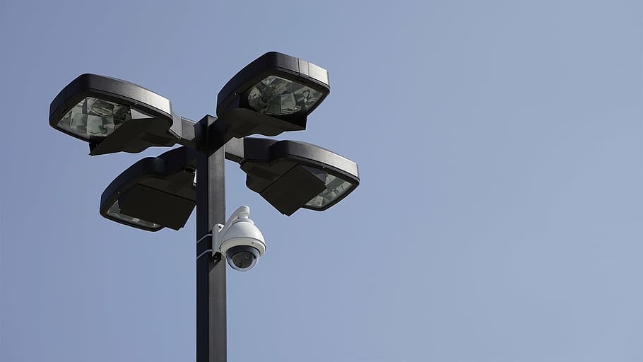 white, surveillance camera, mounted, black, post, camera, parking lot, surveillance, car, park