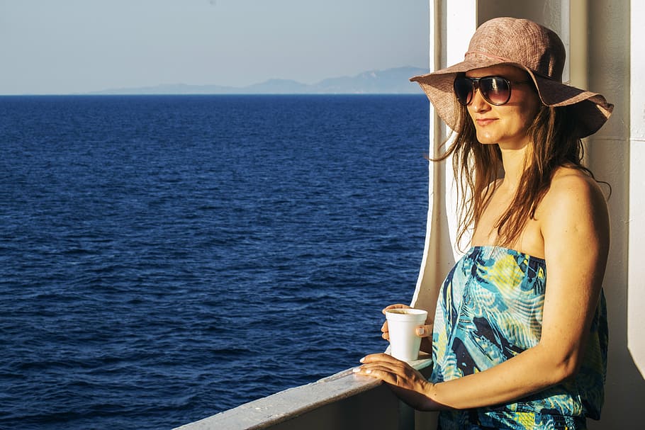 woman, holding, white, cup, girl, looking, away, at the sea, girl looking at the sea, young