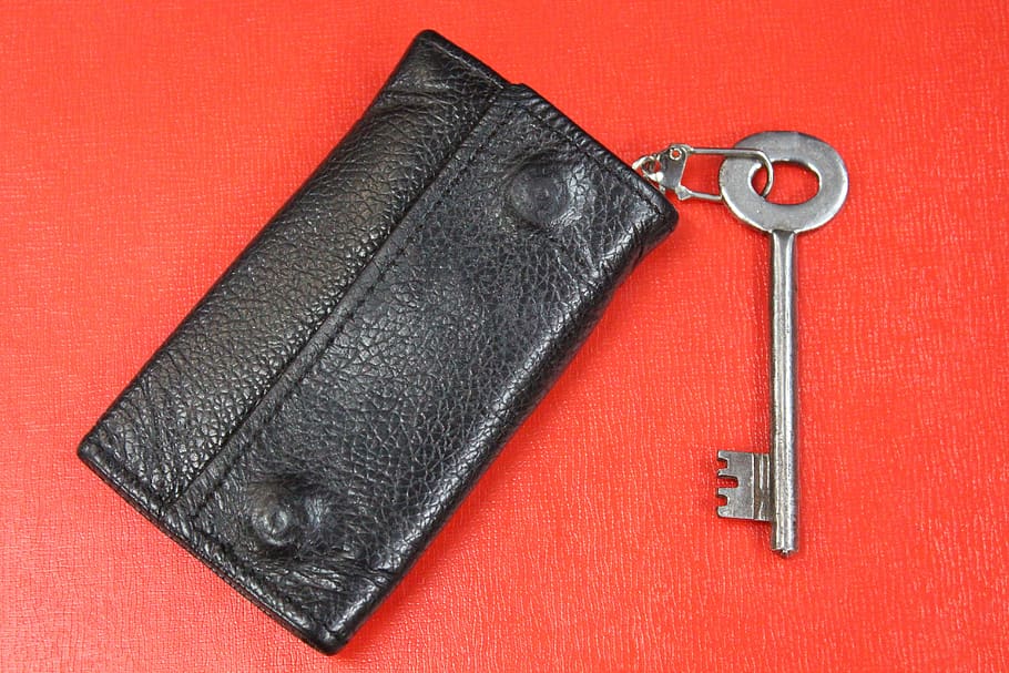 leather key case wallet, key chain, key, red, studio shot, metal, red background, colored background, close-up, work tool