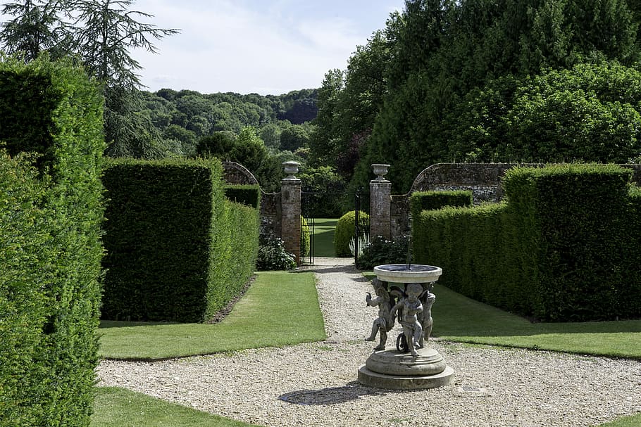 english country garden, formal yew hedges, sundial sculpture, iron gates, brick piers, distant woodland, plant, formal garden, tree, garden