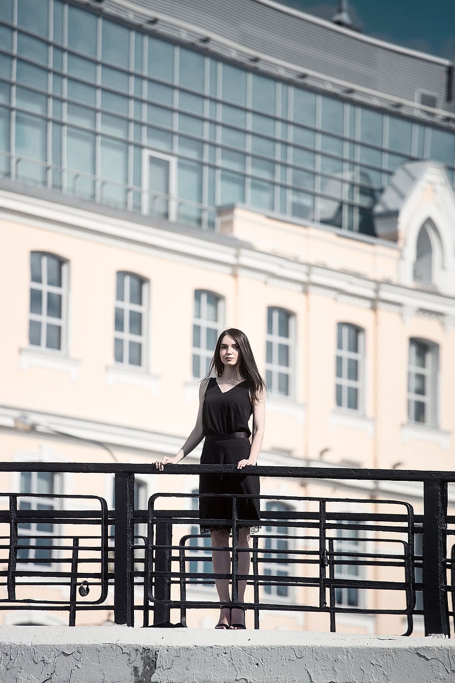 woman, wearing, black, sleeveless dress, concrete, bridge, woman in black, sleeveless, dress, stalin skyscraper