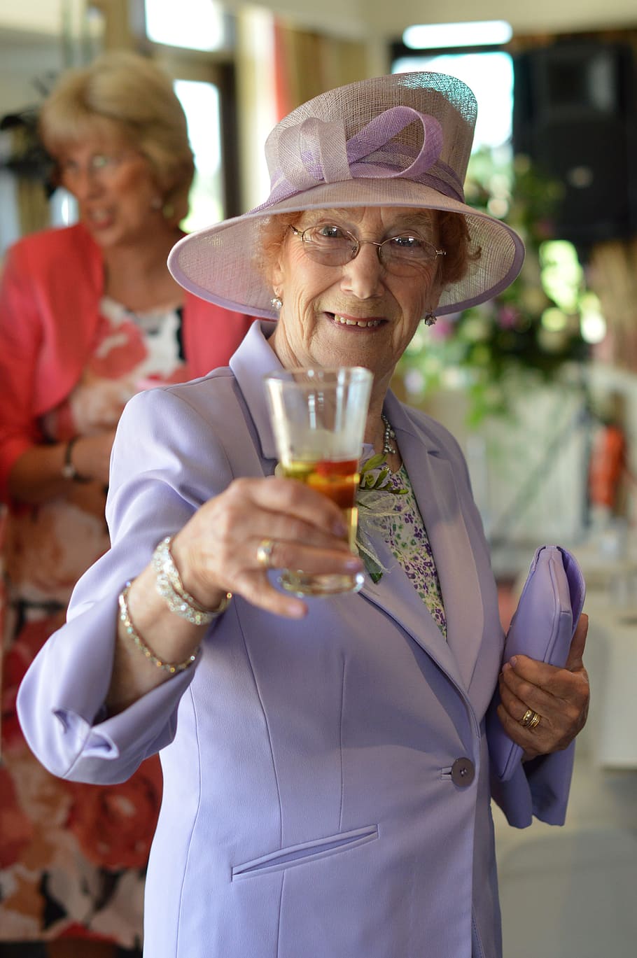 shallow, focus photo, woman, purple, notched, lapel suit jacket, lady, cheers, drink, wedding