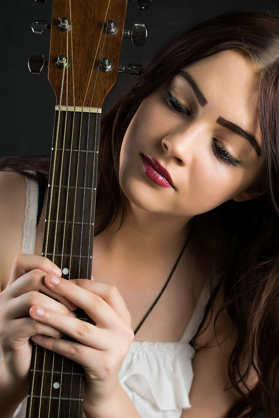 woman, staring, black, guitar neck, holding, hands, beautiful, young, fashion, pretty