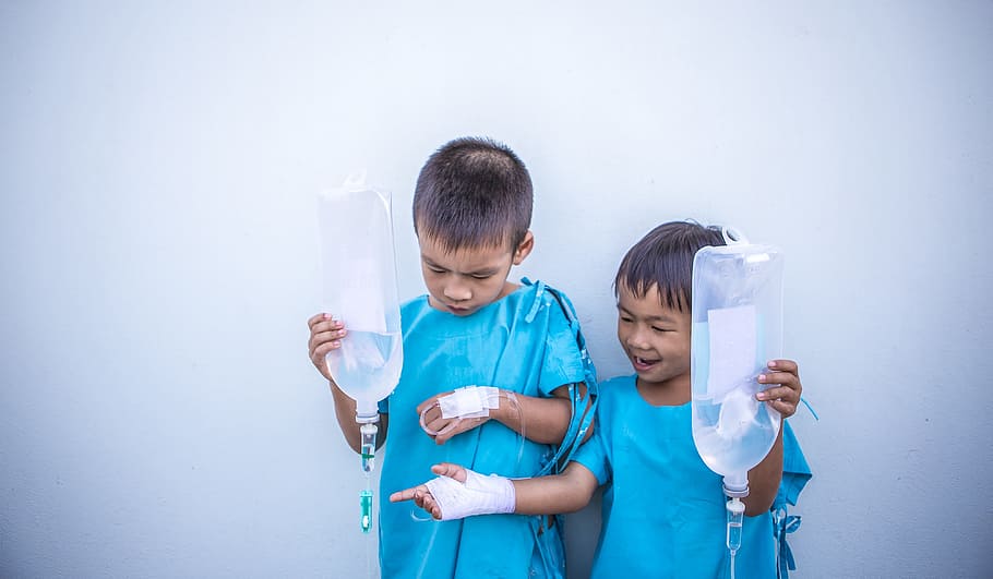 two, patient boys, holding, dextrose bags, children, blue, lab, gown, antibiotics, asia