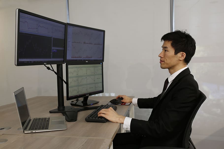 person using computers, computer, office, commercial, laptop, desk trader in the financial multi-screen, businessman, business person, technology, business