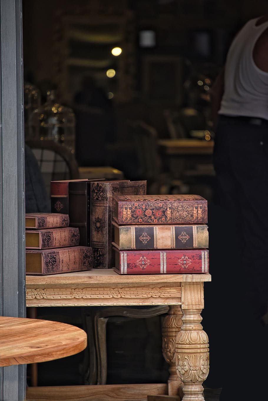 antique dealer, books, old books, bookseller, binders, history, wood - material, table, indoors, focus on foreground