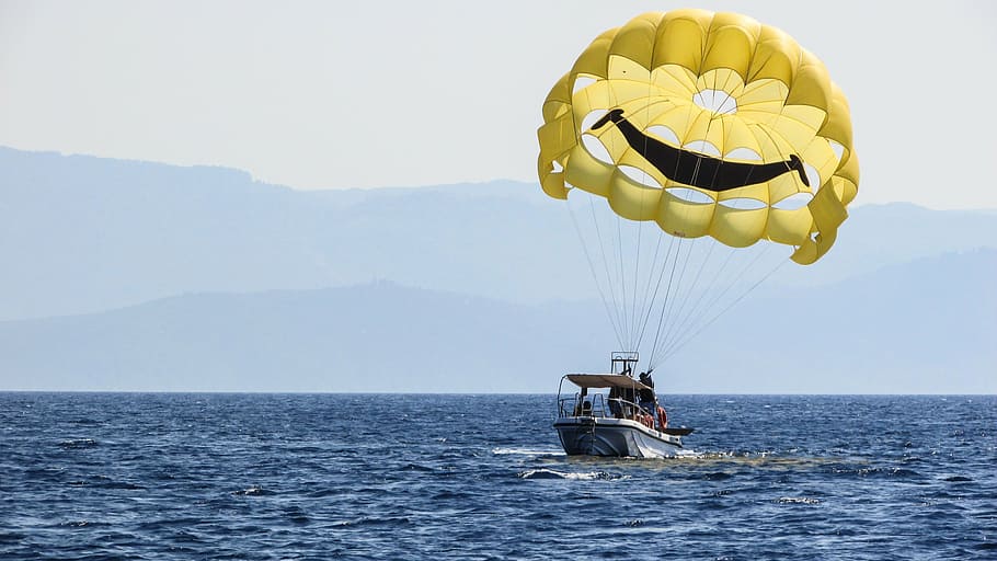 white, motorboat, water, daytime, parachute, paragliding, yellow, balloon, smile, sky