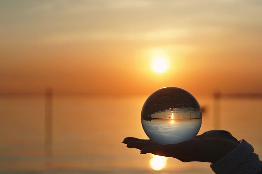 shallow, focus photography, person, holding, crystal ball, sunset, sun, dawn, dusk, sky