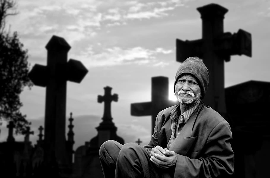 grayscale photo, man, sitting, black, cross, human, mourning, sadness, death, farewell