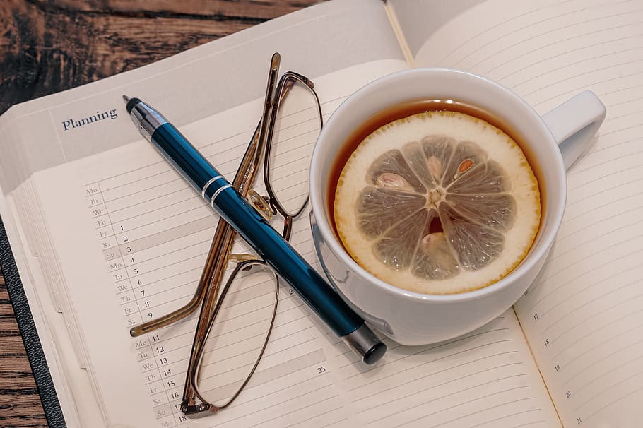 teacup, tee, slice of lemon, glasses, pen, appointment calendar, agenda, break, hot, drink