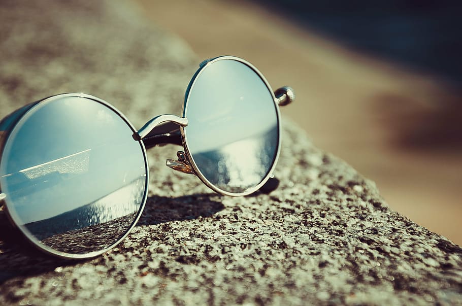 sunglasses on rock, sunglasses, reflection, summer, beach, bokeh. blur, eyewear, rock, adventure, travel