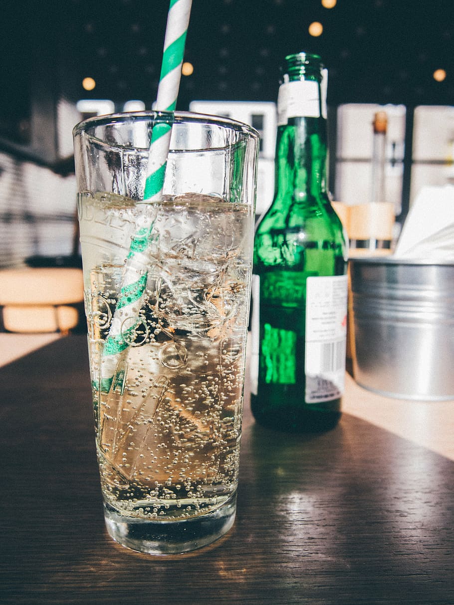 filled, clear, glass, straw, bottle, drinking, green, white, labeled, soda