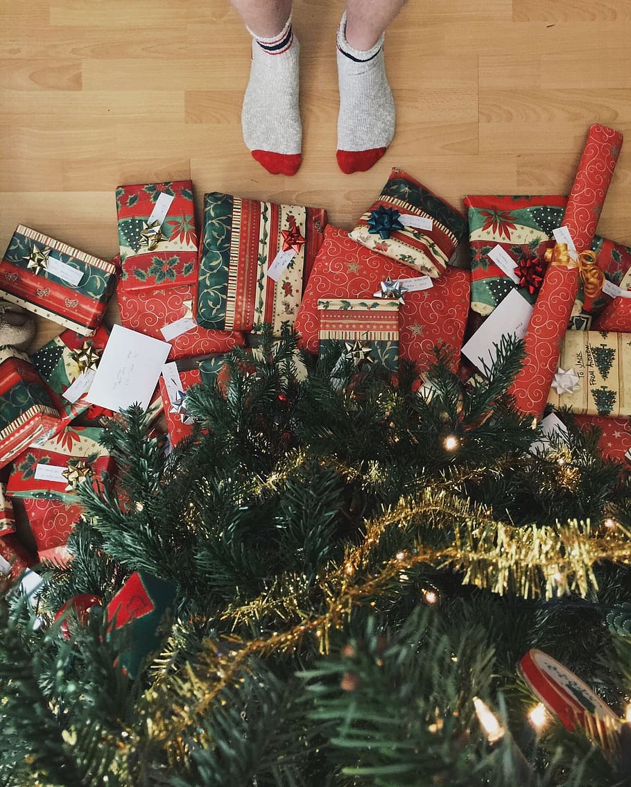 person, standing, infront, christmas tree, gifts, christmas presents, christmas, decoration, holiday, celebration