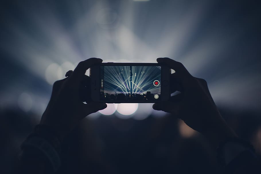 person, holding, smartphone, two, hands, filming, concert, shallow, focus, white