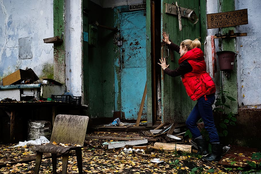 woman pushing door, girl, cinema, angry dog, camp, building, forest, horror, woman, person