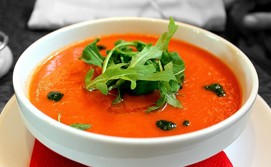 orange, soup, topped, green, leaves, round, white, ceramic, bowl, closeup