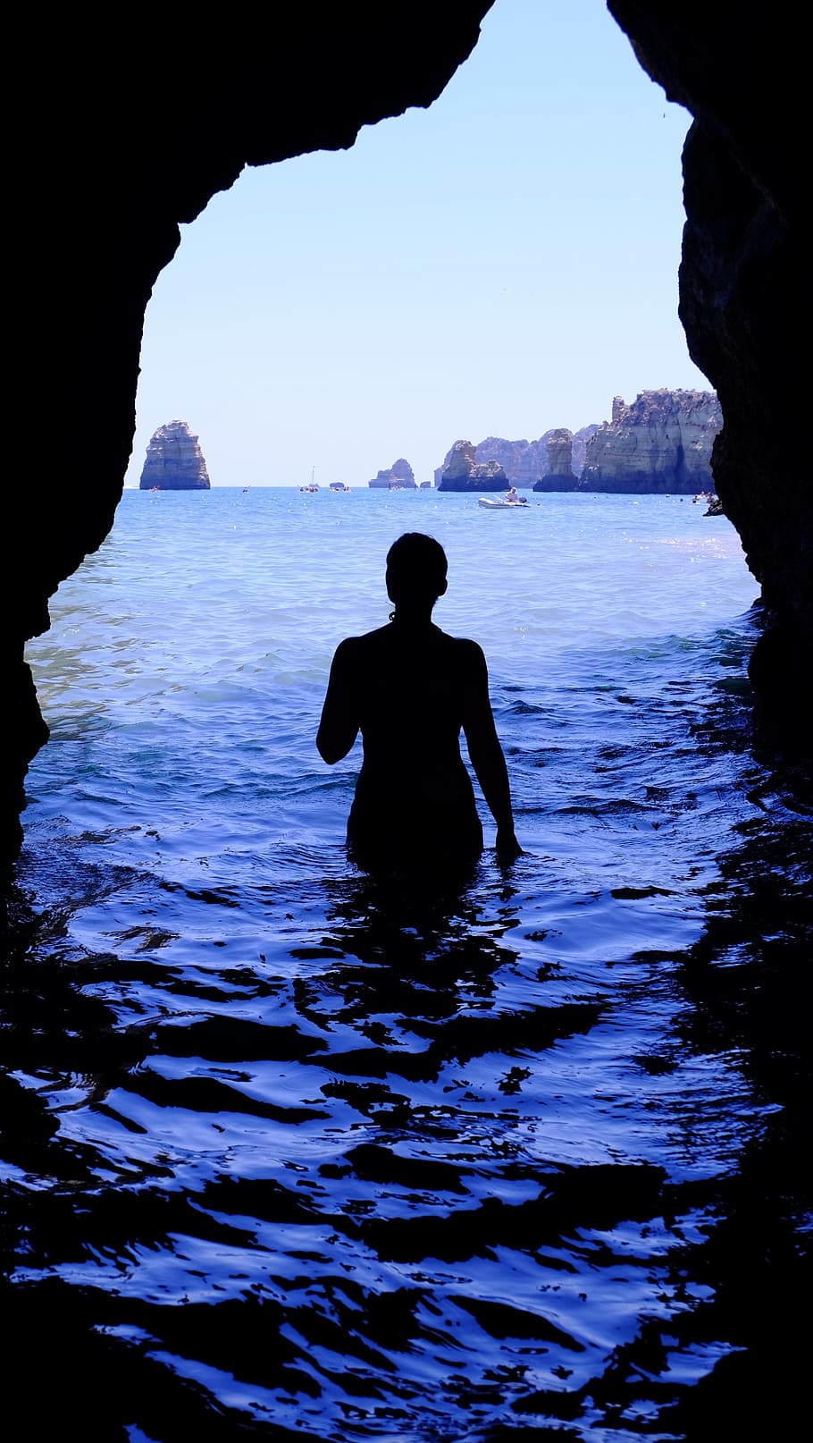 person, walking, inside, oncean cave, daytime, silhouette, woman, alone, swimming, sea