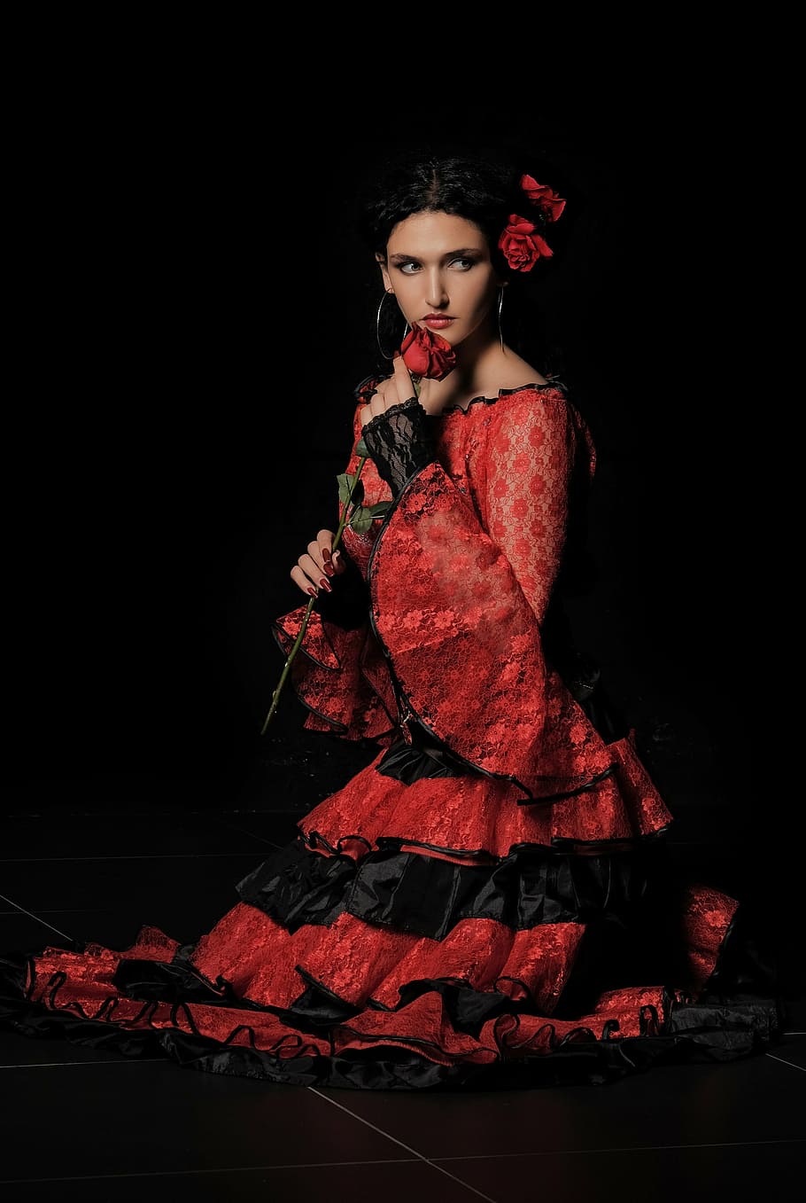 woman, wearing, red, black, long-sleeved, ruffled, dress, holding, rose, background