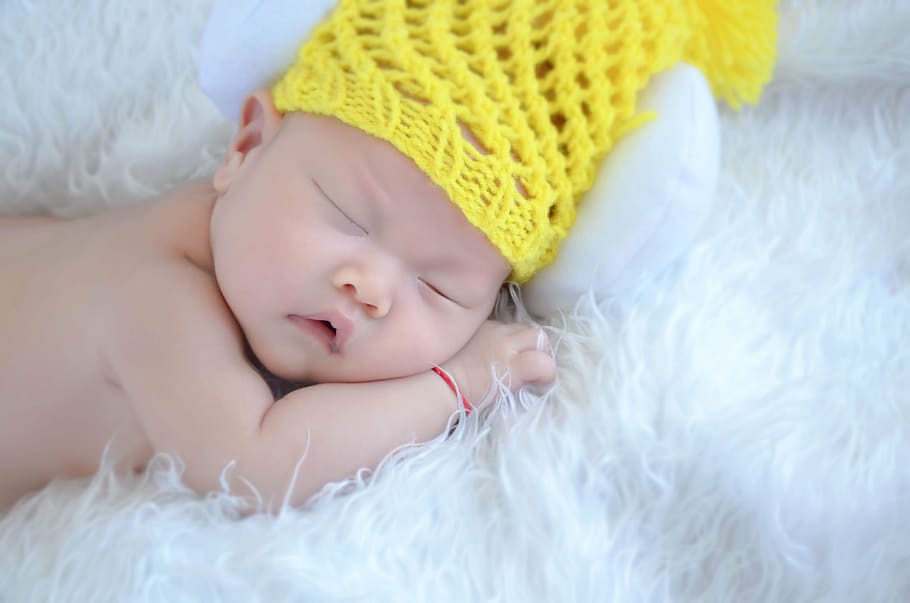 sleeping, baby, wearing, yellow, knit, cap, laying, white, fleece textile, new students