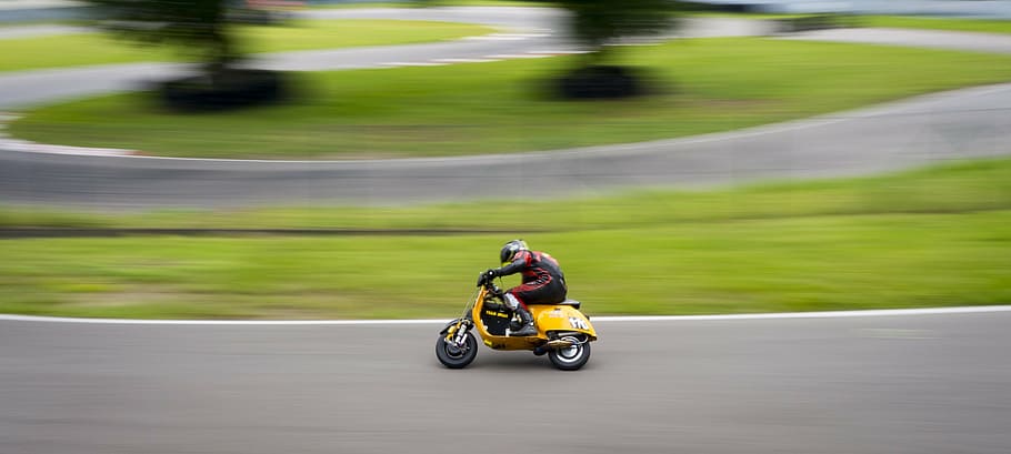 person, riding, yellow, motor scooter, concrete, road, vespa, race, exit, race track