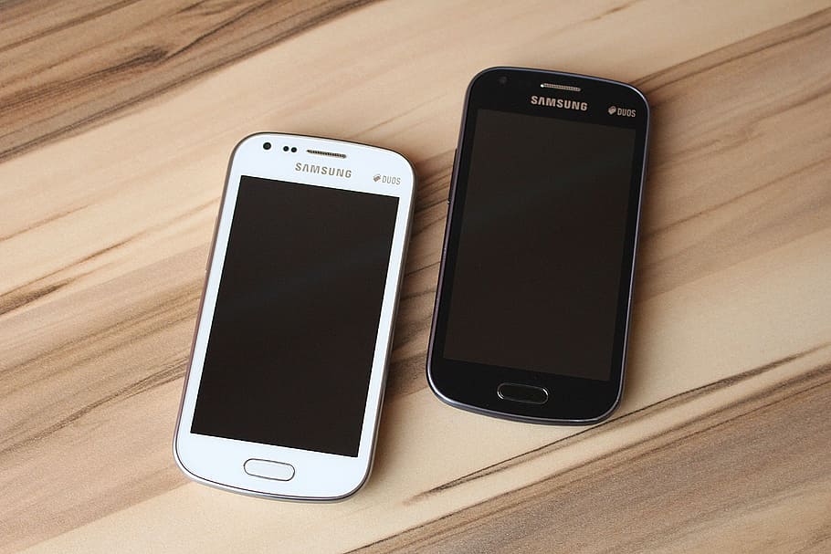 two, white, black, samsung android smartphones, brown, wooden, surface, smartphone, touch screen, mobile phone
