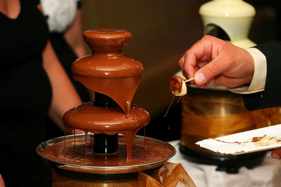 person, standing, front, chocolate fountain, food, dessert, chocolate, food amp drink, hand, food and drink
