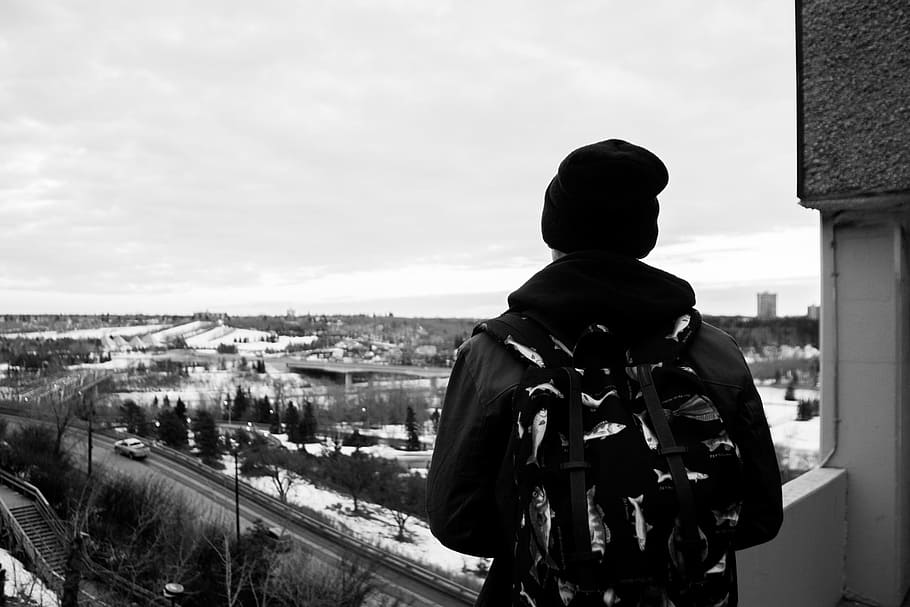 guy, backpack, hat, toque, beanie, city, view, black and white, people, winter