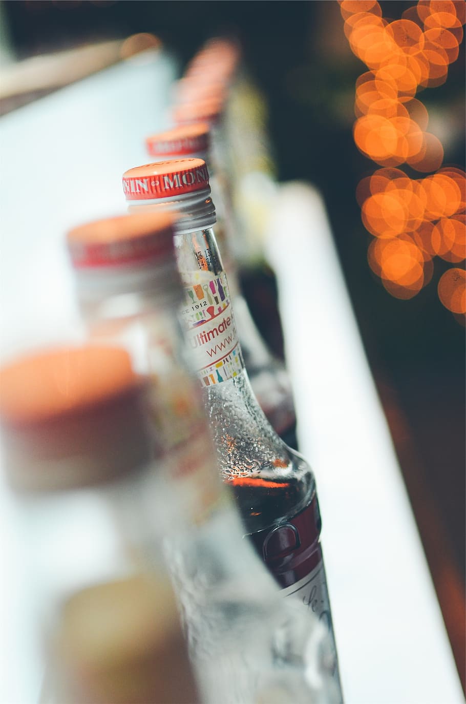bottles, alcohol, bar, close-up, focus on foreground, bottle, selective focus, indoors, still life, food and drink