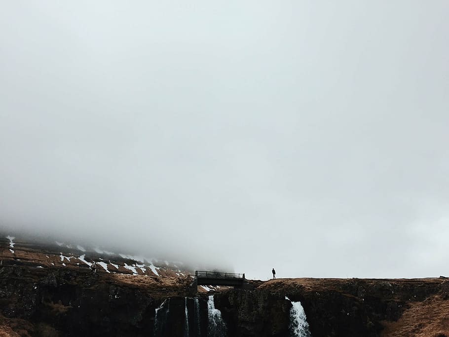 person, standing, bridge, mountain, rock, formation, man, guy, snow, falls