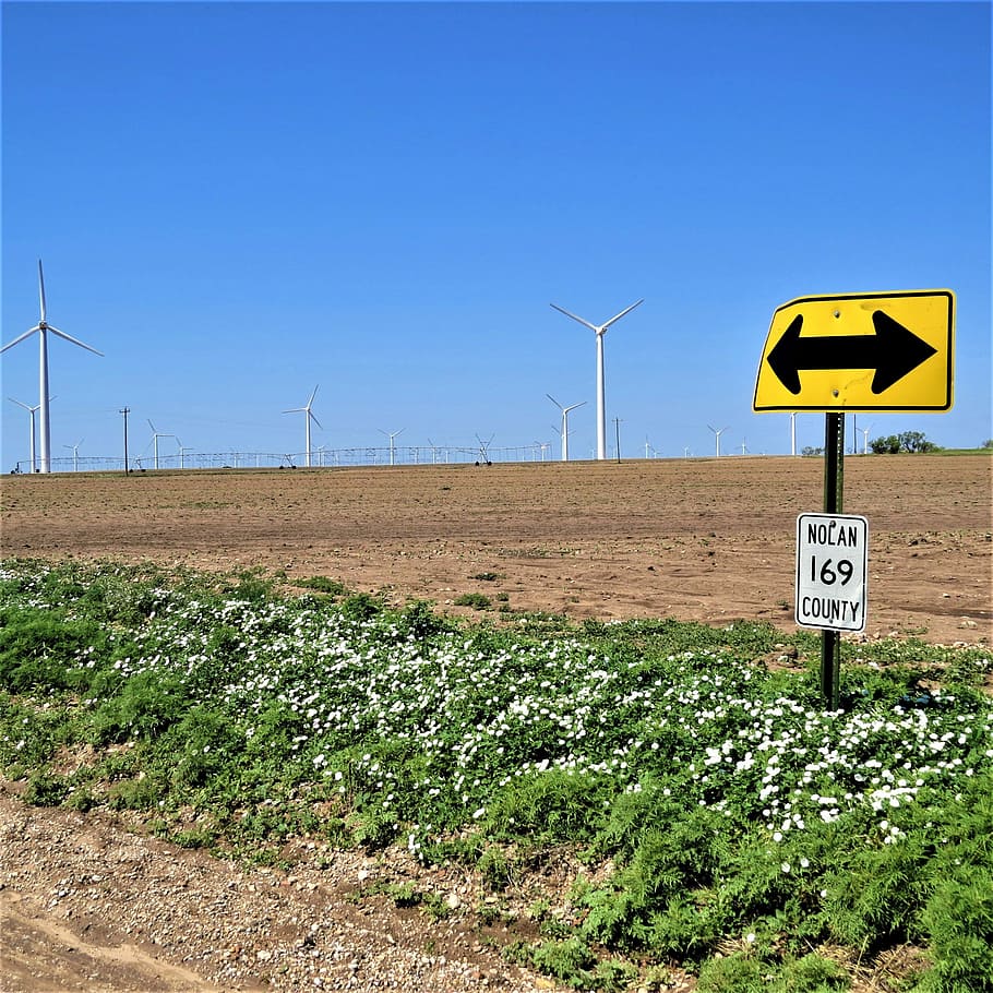 modern windmills, blue sky, road sign, white flowers, sign, sky, communication, environment, nature, landscape