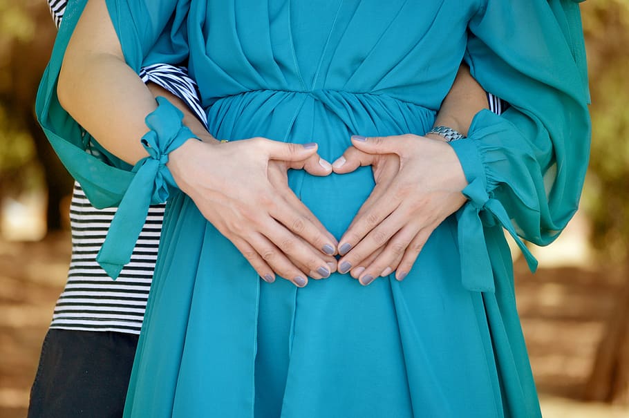 woman, wearing, green, dress, holding, man, hands, love, happy, pregnant