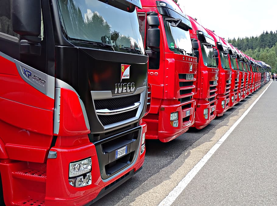 red-and-black trucks inlined, road, formula 1, truck, red, row, transportation, mode of transportation, land vehicle, day