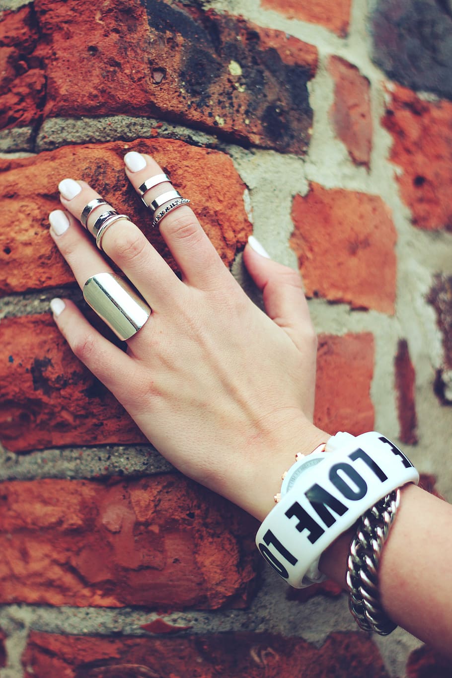 several silver-colored rings, hand, bricks, ring, rings, nails, bracelet, bracelets, human Hand, people
