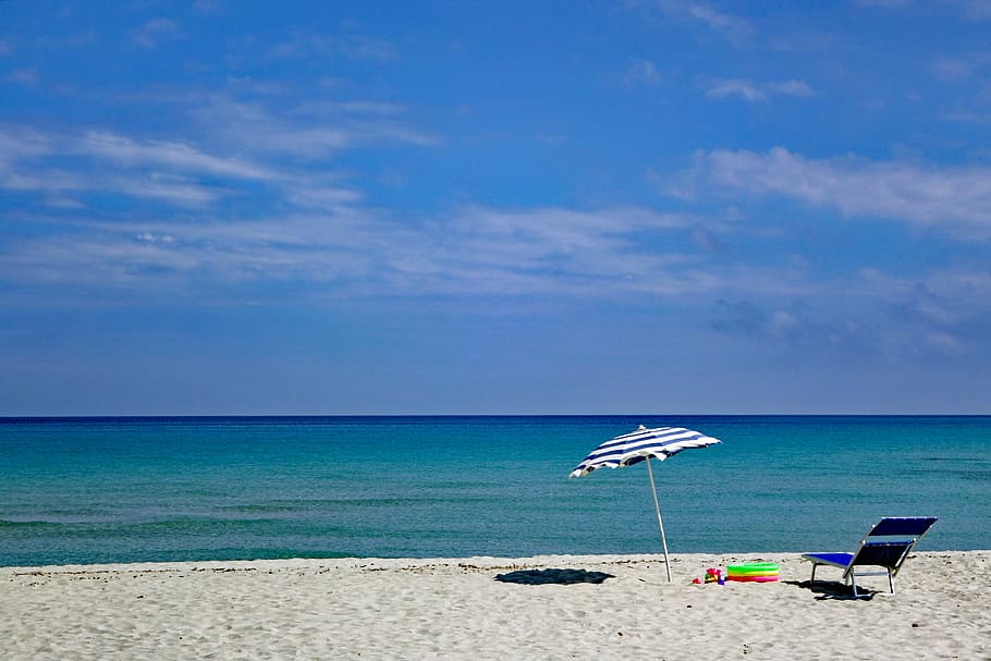 beach photo, daytime, beach, sky, blue sky, clouds, sea, parasol, sun lounger, children toys