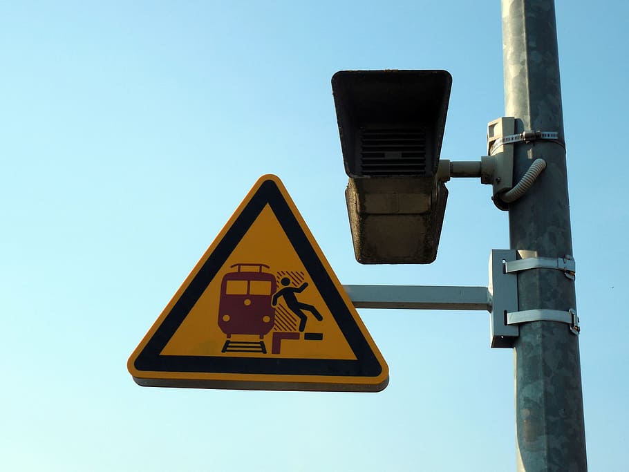 Stumble, Risk, warnschild, railway station, speakers, clear sky, communication, low angle view, camera - photographic equipment, yellow