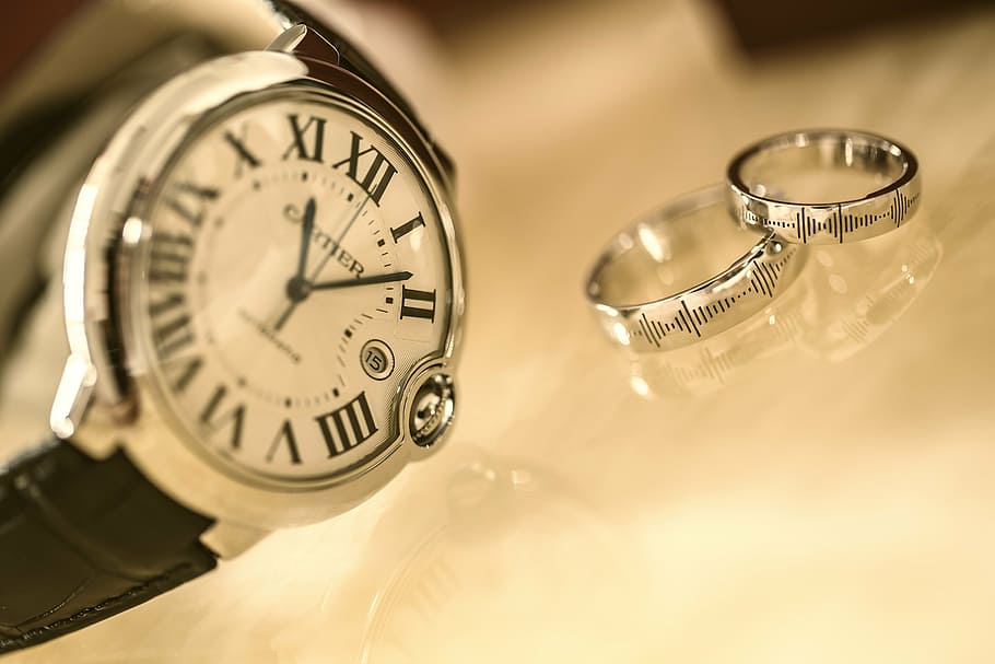 round silver-colored analog, watch, two, silver-colored rings, round, gold, cartier, analog, black, leather