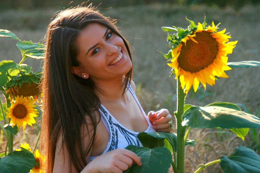 woman facing sunflower, girl, sunflower, smile, field, yellow, flower, flowering plant, plant, one person