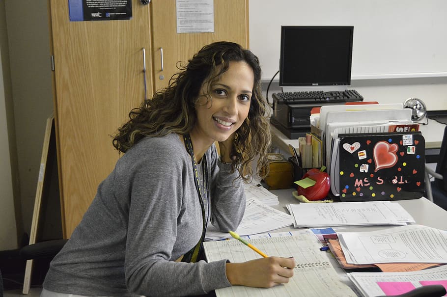 woman, gray, long-sleeved, top, leaning, table, office, teacher, desk, technology