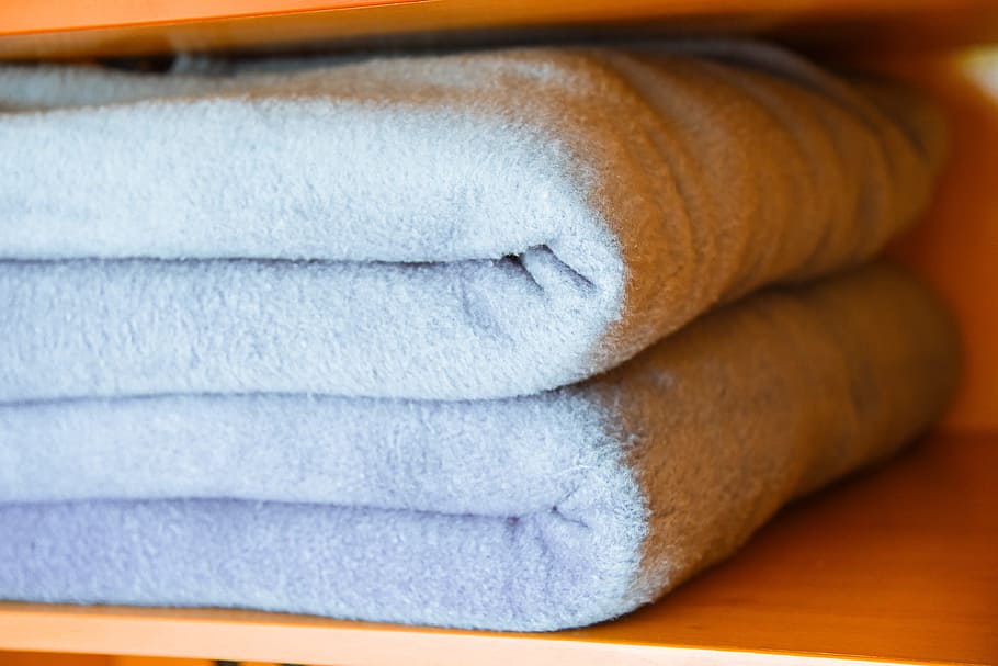 blankets, organization, arm aryan, close-up, indoors, relaxation, stack, textile, towel, group of objects