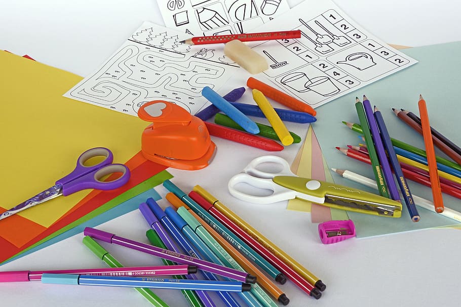 assorted-colored coloring pencils, scissors, sharpeners, papers, panel, felt tip pens, colored pencils, crayons, pens, draw