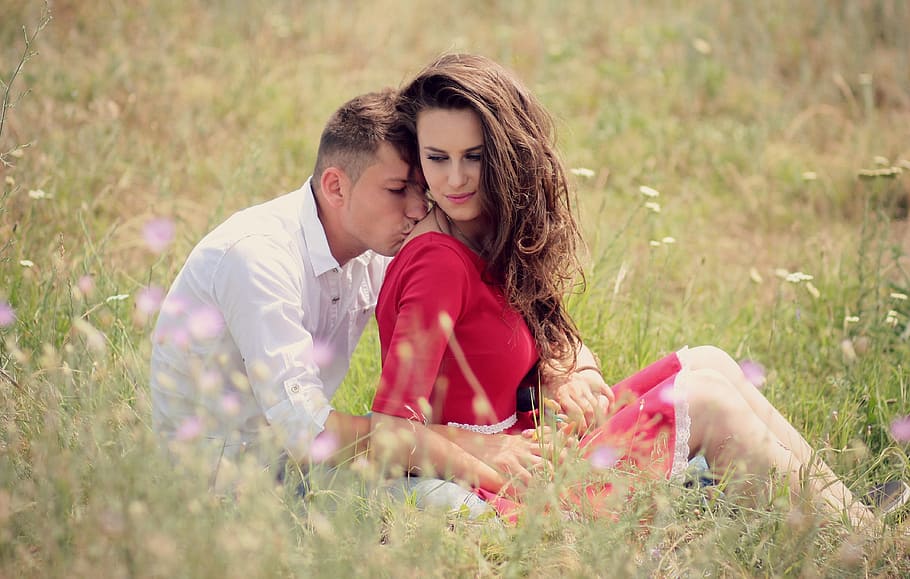 man, woman, sitting, grass field, daytime, couple, love, kiss, girl, boy