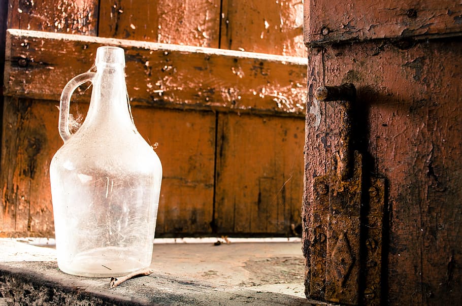 clear glass carboy, glass, cellar, door, rust, wood door, old, container, wood - material, day