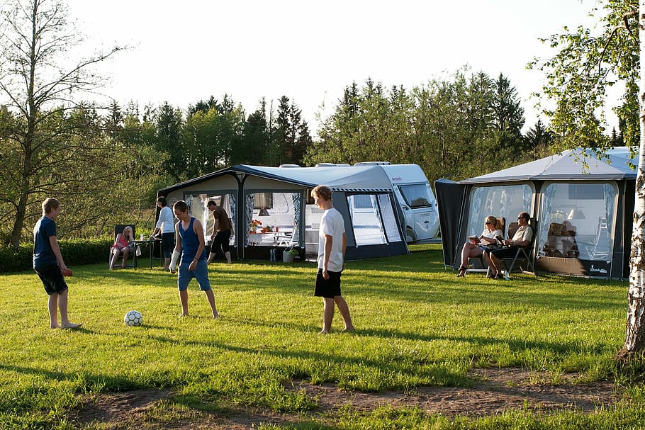 people, grass field, tv trailers, camping, holiday, outdoor, plant, group of people, tree, real people